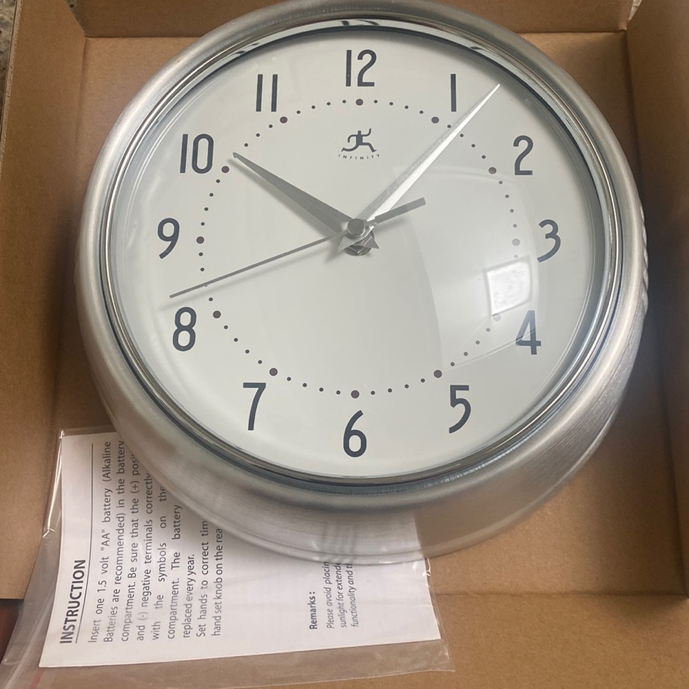 Wall clock from INFINITY. diameter 9.5” metal wall clock. Silver in color .